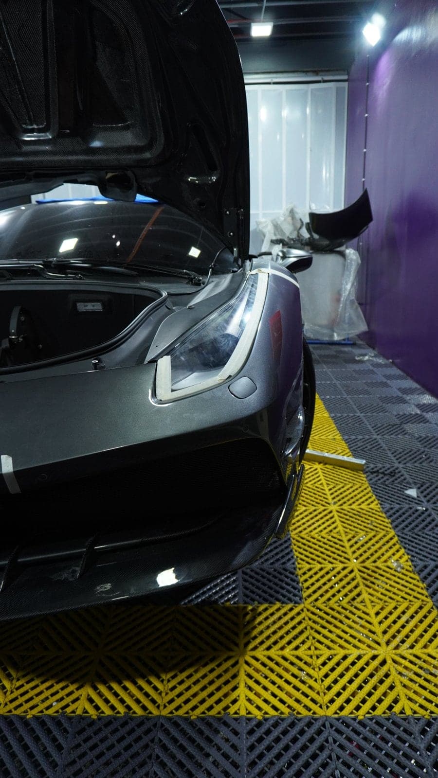 Ferrari 488 front end with carbon fibre bonnet and splitter during body kit installation