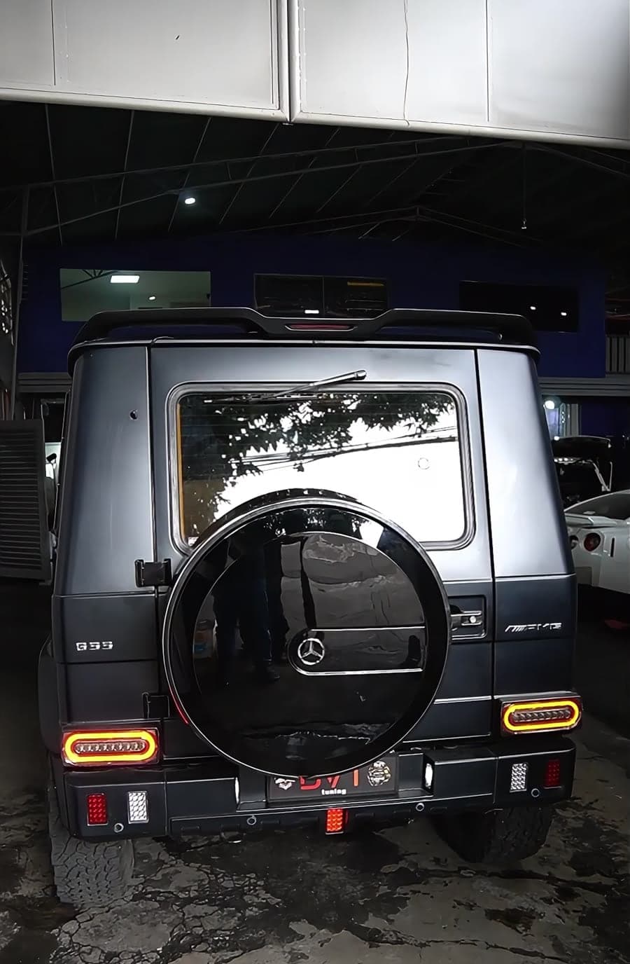 Rear of a matte black Mercedes G55 AMG with aftermarket LED tail lights