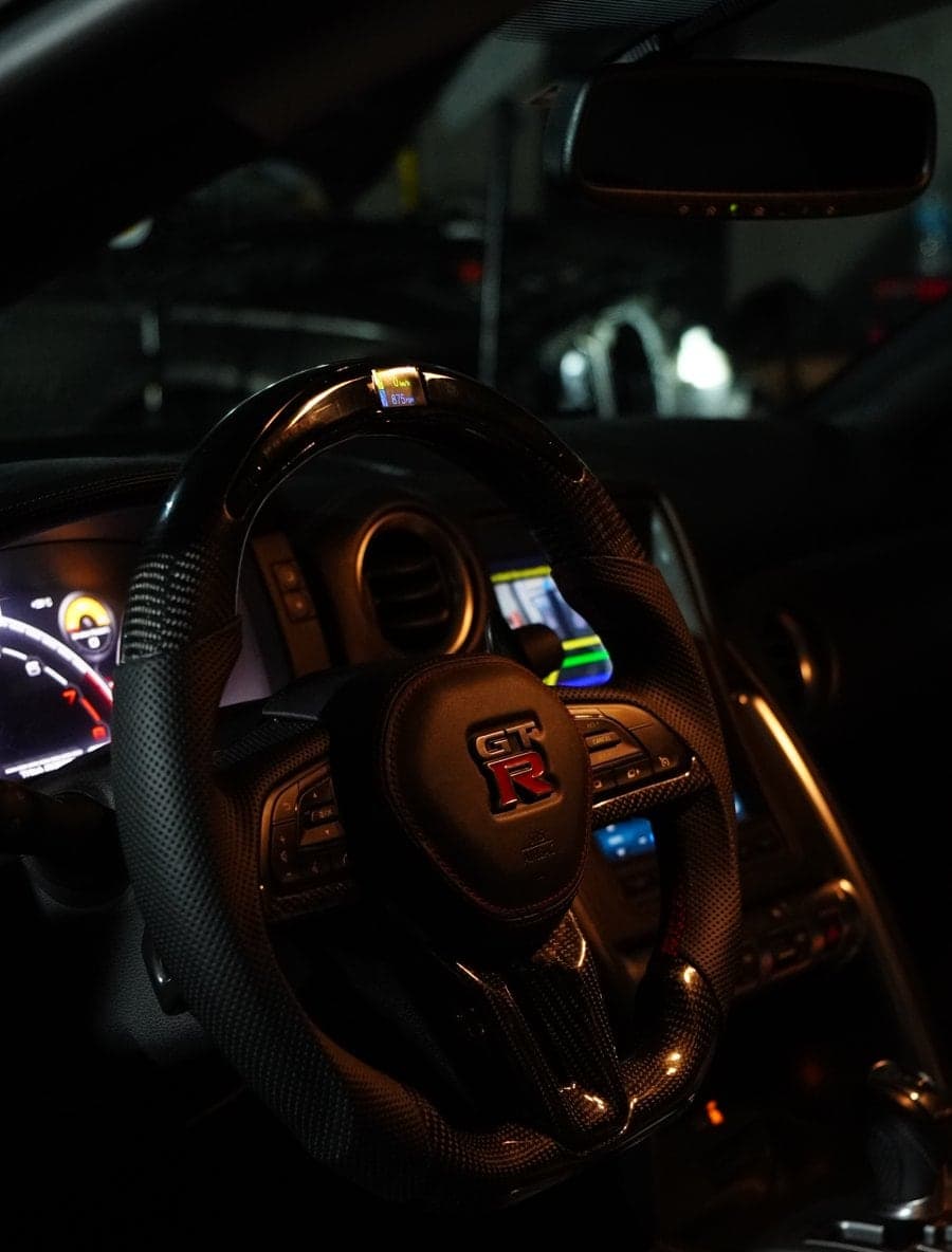 Carbon fibre and perforated leather steering wheel with LED display in a Nissan GT-R