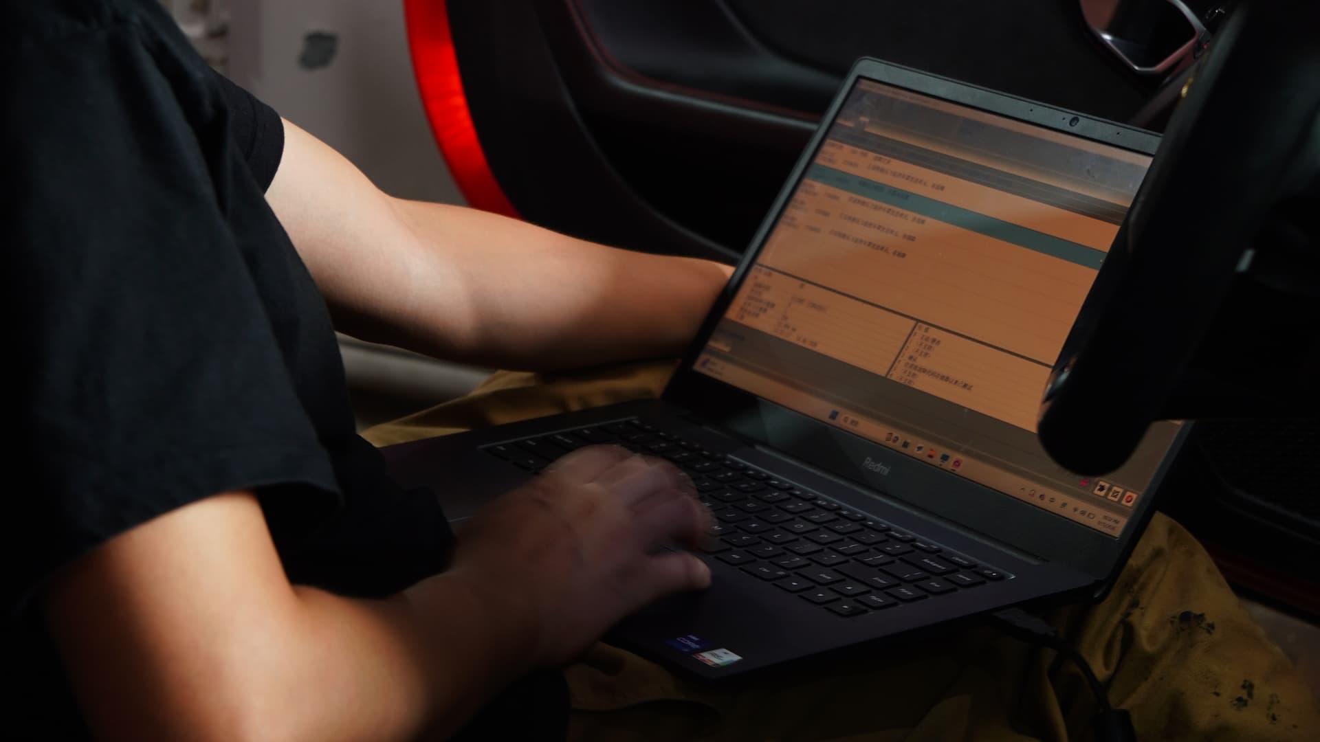 Technician coding a Lamborghini Huracan from a laptop in the driver seat at BVT Tuning
