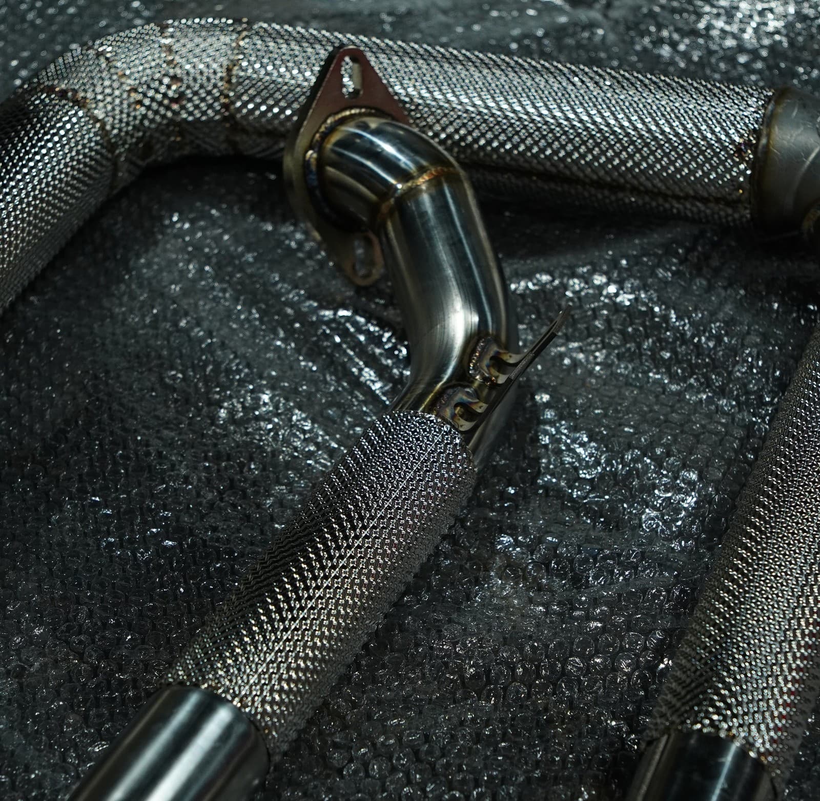 Downpipe flange fitted at the turbo on a Porsche 718 Cayman S