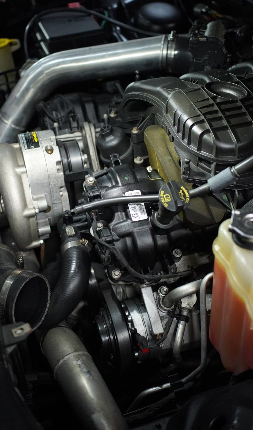 Supercharged Dodge Challenger engine bay with polished aluminium intake piping