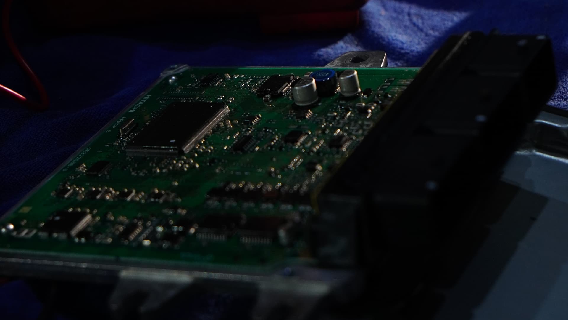 ECU circuit board on the bench next to diagnostic tools at BVT Tuning