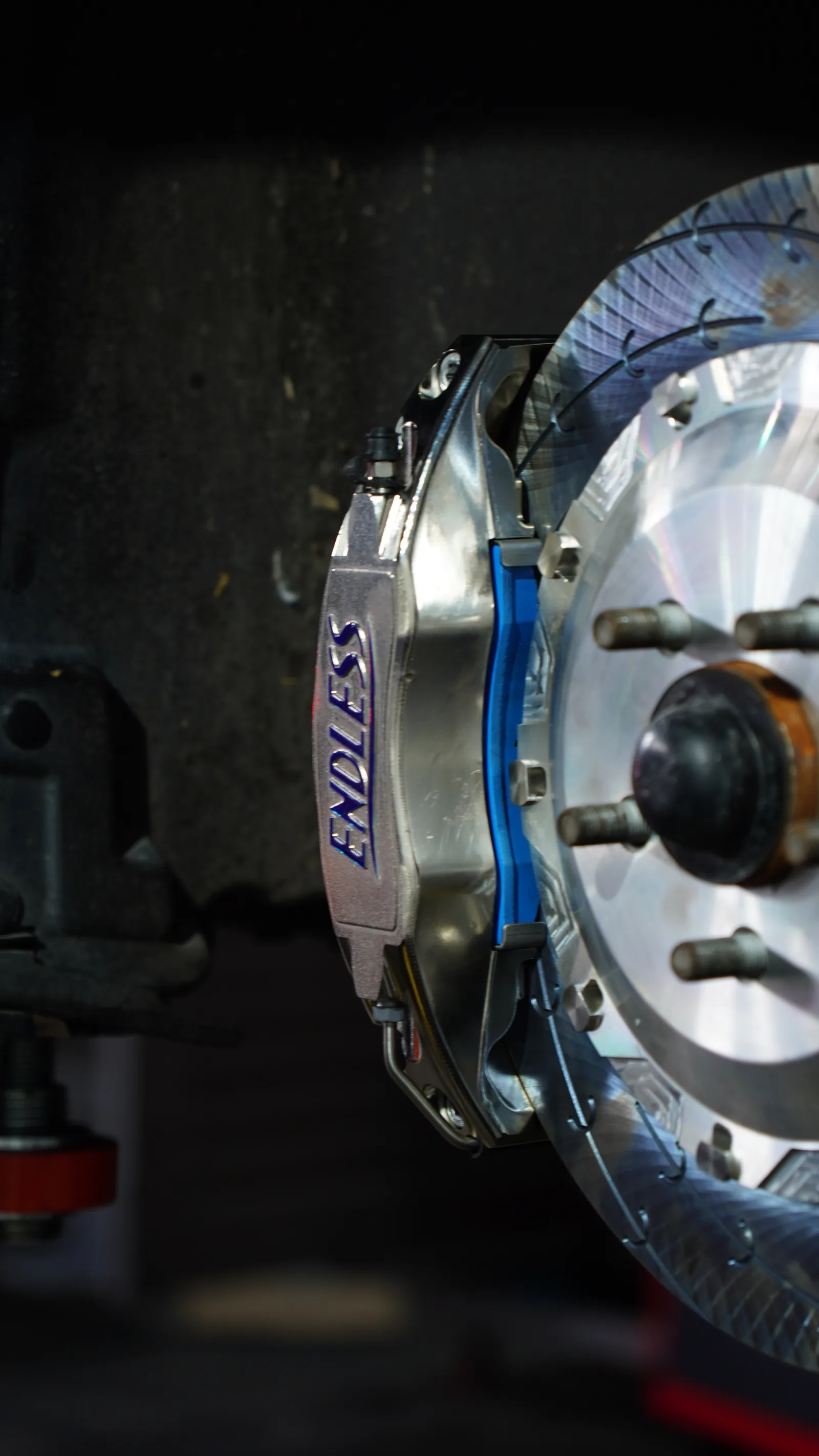 Endless big brake kit caliper over a slotted two-piece rotor on a Ford Mustang GT front hub