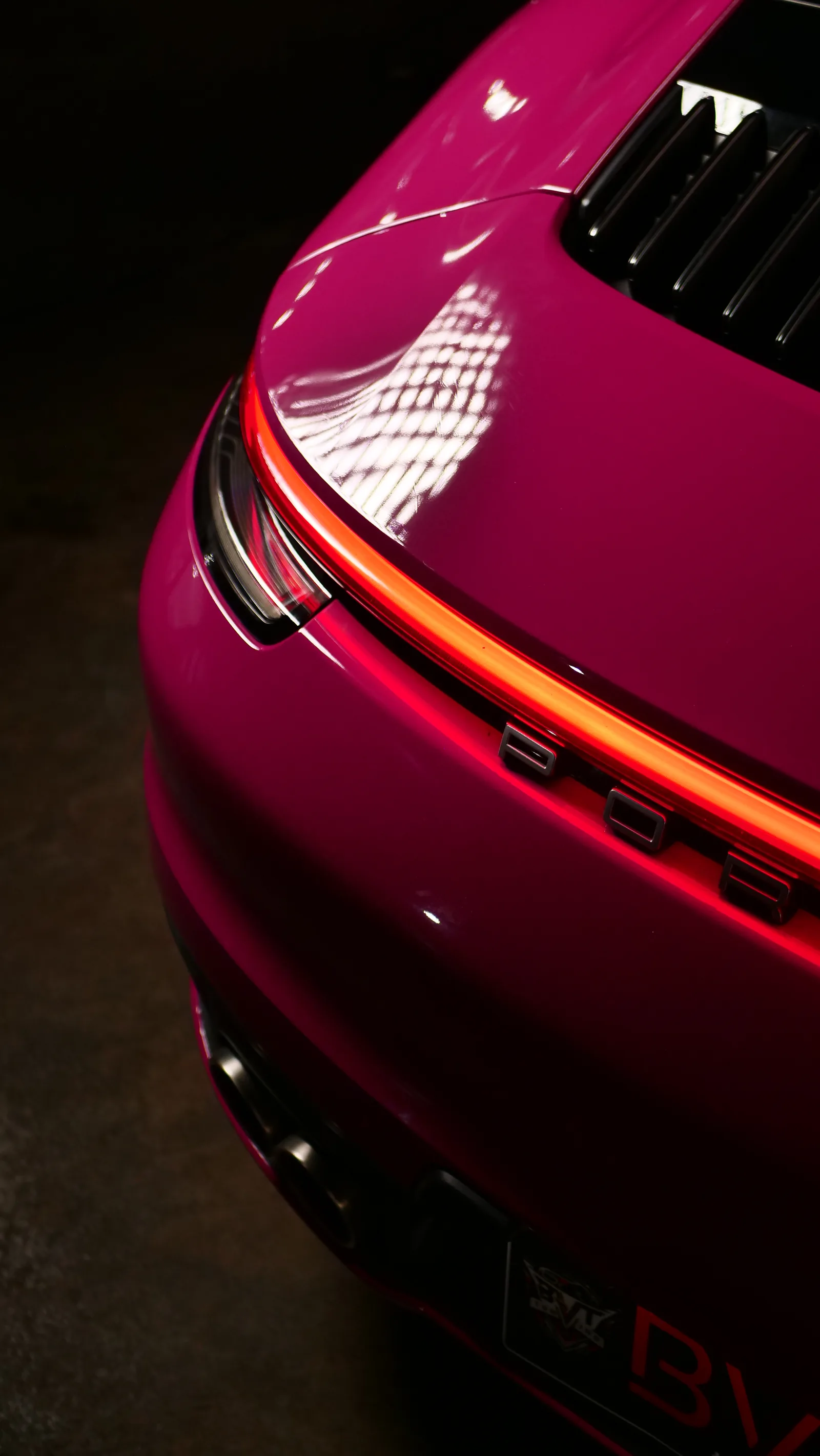 Porsche 911 Carrera S rear light bar glowing over the Shinobi Pink Gloss colour PPF engine lid