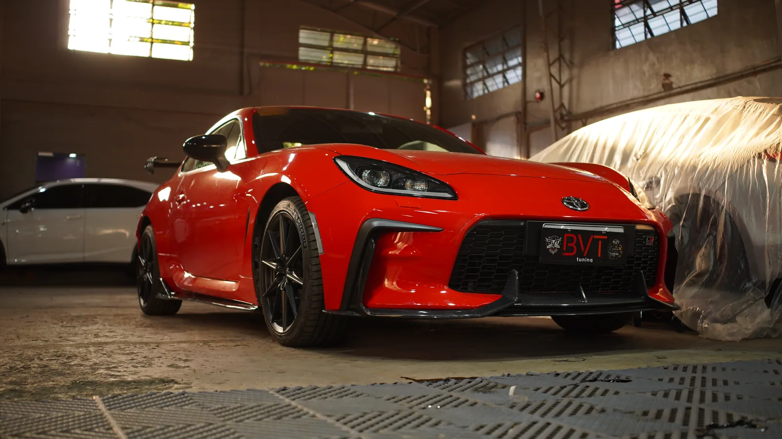 Red Toyota GR86 with the Adro kit and carbon front lip in the BVT workshop