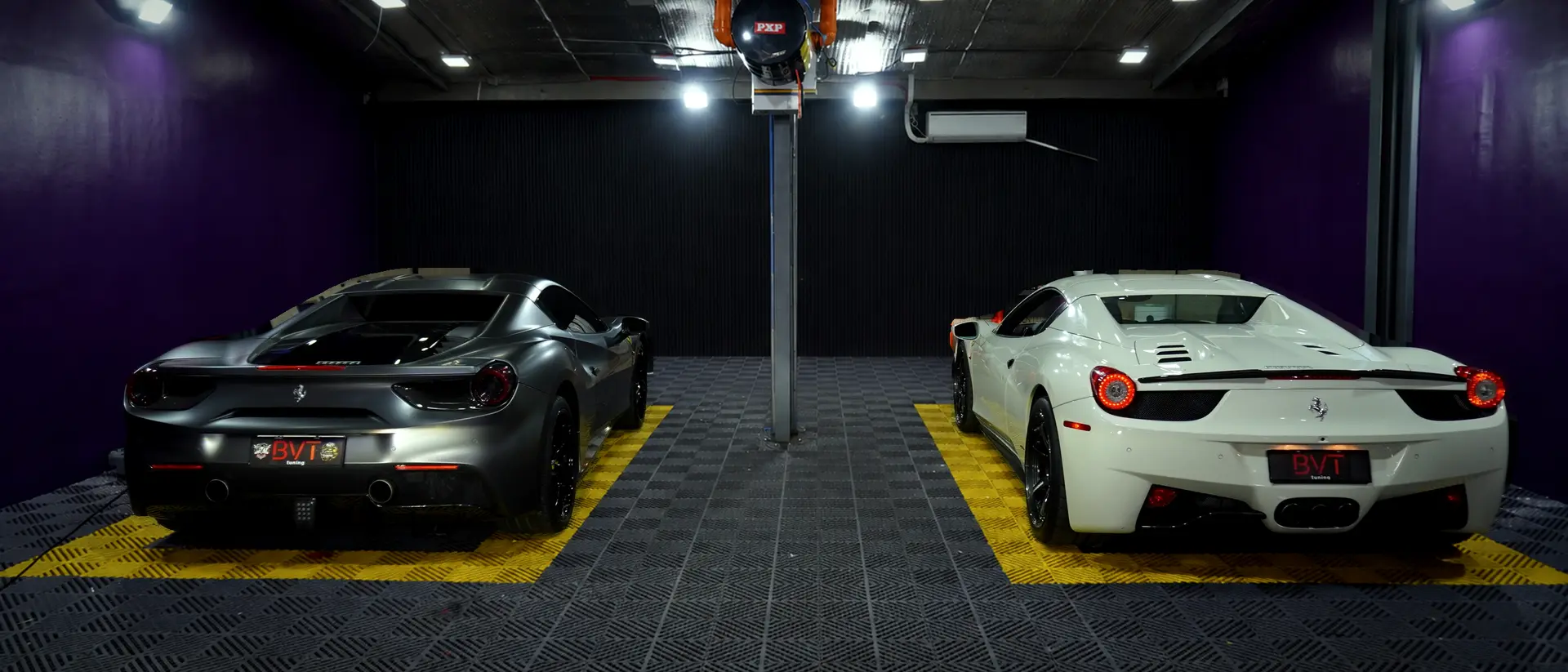 Two Ferraris in the clean purple BVT Tuning install bay